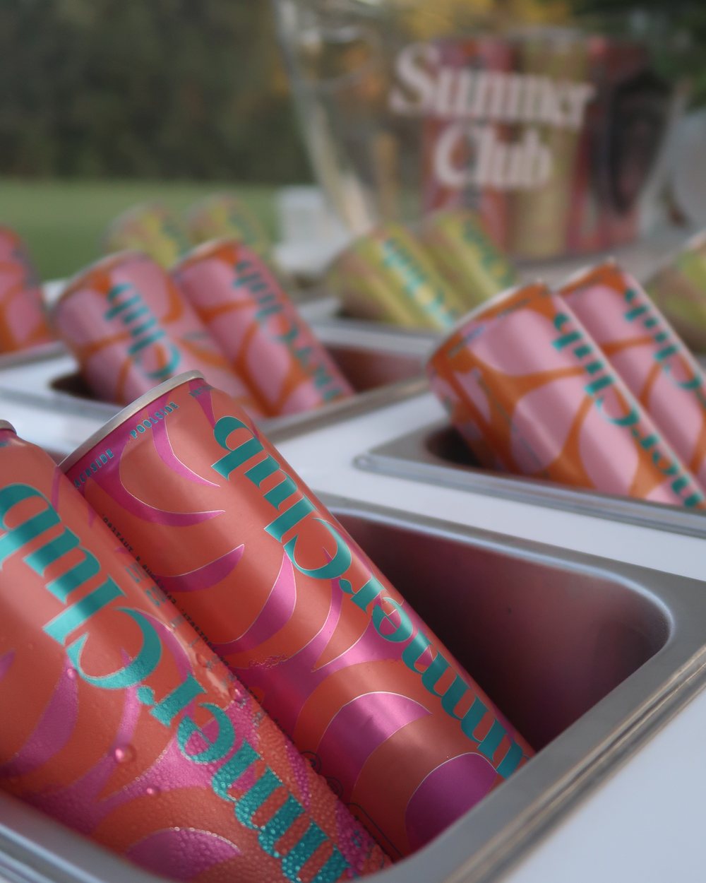 Close-up of branded cans chilled on the beverage cart